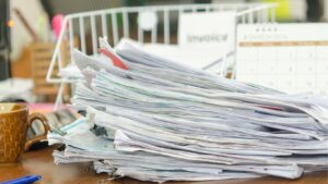 A pile of paperwork on a desk.