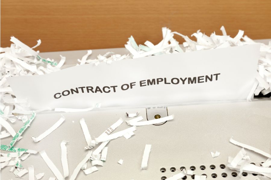 paper being shredded with the words "contact of employent"