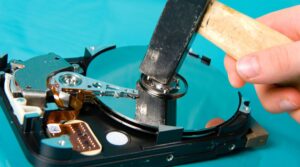 hammer hitting an old hard drive